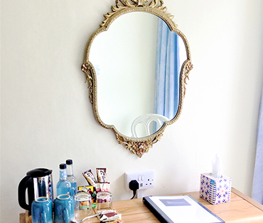 A mirror with some tea making facilities